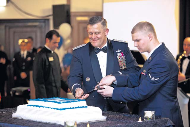 Photo by Staff Sgt. Steven PriceGen. Frank Gorenc, U.S. Air Forces in Europe and Air Forces Africa commander, and Airman 1st Class Dillon Fowler, 86th Communications Squadron Cable Maintenance Section, cut the birthday cake during the Air Force Ball Oct. 26.