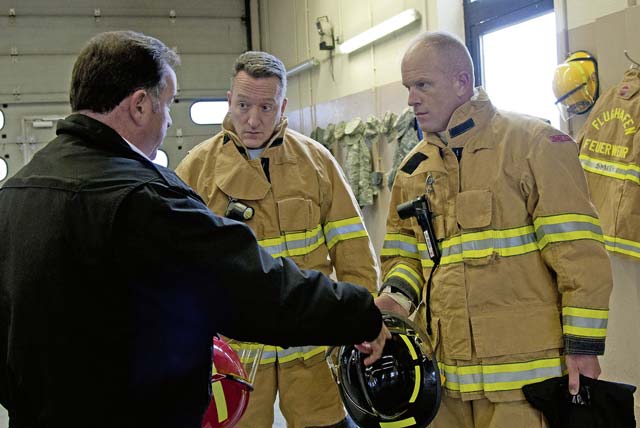 Randall D. Marshall Sr. (left), 86th Civil Engineer Squadron KMC Fire and Emergency Services fire chief, explains the meaning of the color of firefighter helmets to Brig. Gen. Patrick X. Mordente (center), 86th Airlift Wing commander, and Chief Master Sgt. Frank H. Batten III, 86th AW command chief, Nov. 19 on Ramstein.