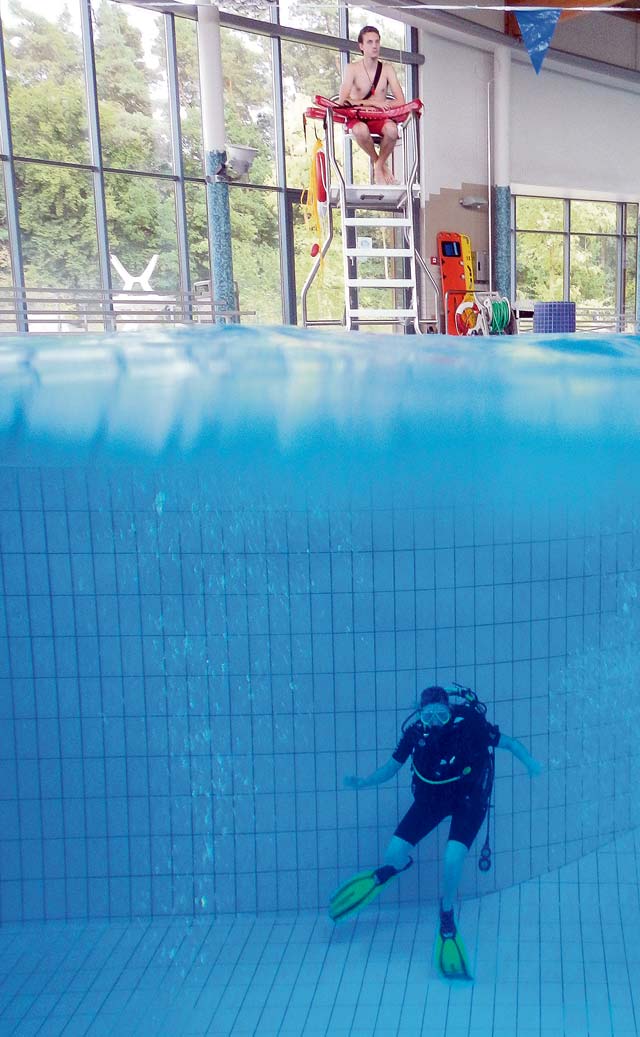 A scuba diving student spends several hours diving in the pool in order to earn certification.