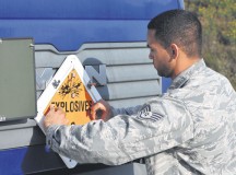 Staff Sgt. Brian Warner, 86th Munitions Squadron munitions storage crew chief, posts an explosive placard on the front of a tractor to ensure 
the proper hazard class is displayed while munitions are transported Aug. 22 on Ramstein. The munitions will be transported to an in-transit 
munitions facility where they will be shipped in support of worldwide operations.