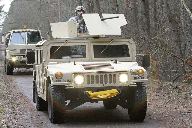 Photo by Sgt. Daniel FriedbergA convoy of 361st Civil Affairs Brigade, 7th Civil Support Command, vehicles moves through the forest Jan. 11 on Rhine Ordnance Barracks.