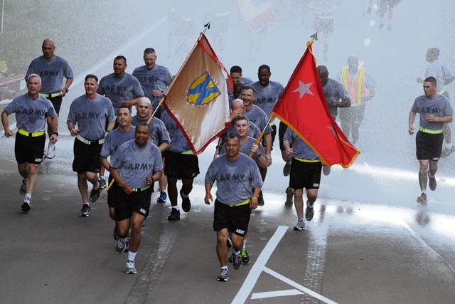 Photo by Staff Sgt. Alexander BurnettMaj. Gen. Aundre F. Piggee (left) and Command Sgt. Maj. Michael A. Sanchez (right), the 21st Theater Sustainment Command’s commanding general and command sergeant major, lead the “First in Support” command team on an “esprit de corps” run to celebrate the U.S. Army’s 238th birthday June 13 on Rhine Ordnance Barracks. The run marked the first celebratory event of the day. 