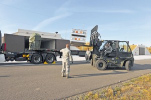 Staff Sgt. Brian Warner, Senior Airman Matthew Dankiewicz and Airman 1st Class David Shelton, 86th Munitions Squadron munitions storage crew members, load munitions onto a trailer.