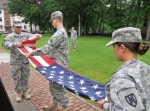 Photo by Staff Sgt. Warren W. Wright Jr.Staff Sgt. Yisey Aponte, a mortuary affairs specialist with the 21st Theater Sustainment Command and a native of Puerto Rico, folds the American flag as Spc. Chase Webb, a native of Cincinnati, and Pfc. Marygrace Phillips, a native of Chicago, both with the 21st TSC, hold the flag during a retreat ceremony Monday on Panzer Kaserne in Kaiserslautern. Soldiers of the 21st TSC participate in the reveille and retreat ceremonies daily, including the weekends, in recognition of military tradition and in honor of the flag.