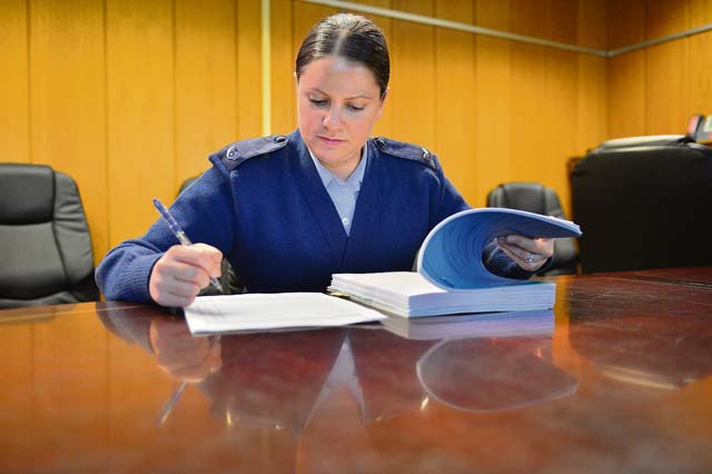 Photo by Tech. Sgt. Daylena RicksStaff Sgt. Barbara Coddington, 86th Airlift Wing Legal Office military justice paralegal, reviews and blocks a case file for trial. Blocking consists of completing a checklist ensuring the entire trial record is assembled in one file. The office provides free legal assistance to service members, Department of Defense civilian employees, DOD contractors and their dependents.