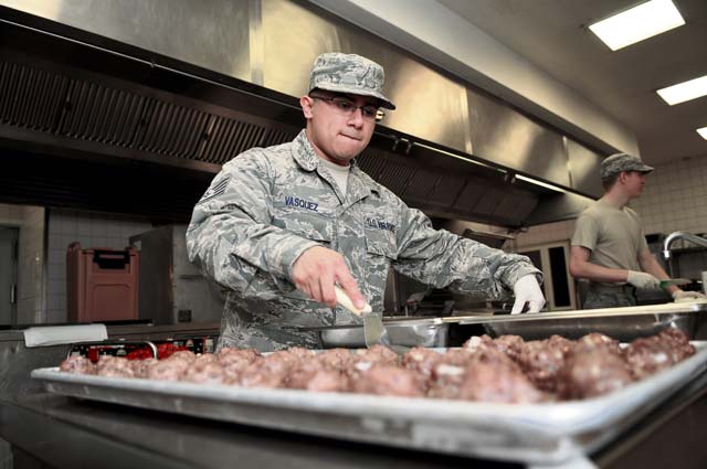 Staff Sgt. Ruben Vasquez, 786th Force Support Squadron food service supervisor, removes meatballs from a baking sheet Oct. 7 on Ramstein. The Rhineland Inn Dining Facility offers four meals a day in order to provide a low-budget meal option for Airmen working around the clock.
