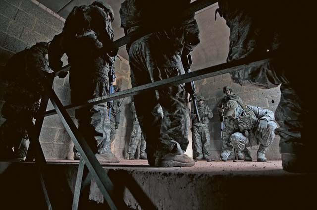 Photo by Senior Airman Damon KasbergStaff Sgt. Christopher Whiting, 435th Security Forces Squadron cadre, shows Airmen proper tactics when breaching a building in confined areas  Feb. 8 in Baumholder. The 435th SFS trains Airmen from throughout the Air Force to prepare them for deployments around the world. The security forces members sharpened many of their skills, including mounted and dismounted  tactics, tactical combat care, weapons firing, and night vision operations.