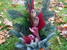 Family members and friends place dried flower bouquets, candles and wreaths on gravesites at German cemeteries Saturday during All Saints Day.