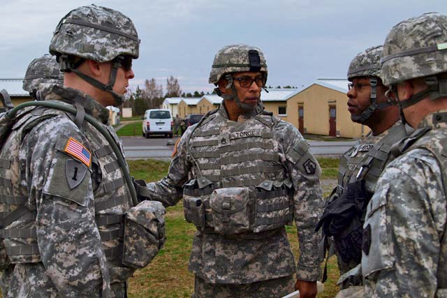  Staff Sgt. Jorge Tonge (center), platoon sergeant, 1st Platoon, 406th Human Resources Co., 21st Theater Sustainment Command’s 7th Civil Support Command, reviews convoy safety procedures with his leadership team before moving out to the rifle range April 19.