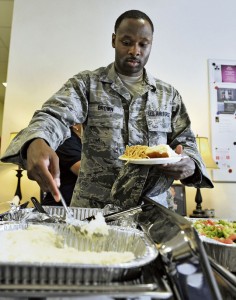An Airman grabs a bite to eat at the home-cooked meal event at Club 7.