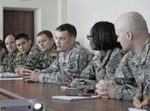 Sgt. 1st Class Ludwig Schweinfurth (center), medical NCOIC with the 773rd Civil Support Team, 7th Civil Support Command, speaks with Moldovan army Nuclear, Biological, Chemical Company Soldiers during a U.S. European Command sponsored CBRN capabilities brief and information exchange Dec. 3.