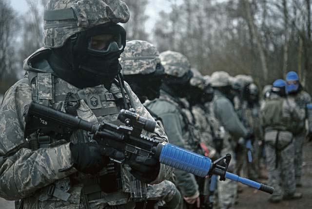 Photo by Sara PavichSecurity forces members line up to have their weapons cleared of simulation rounds. Airmen participated in the 19-day urban operations base security operations course to hone their  skills. 