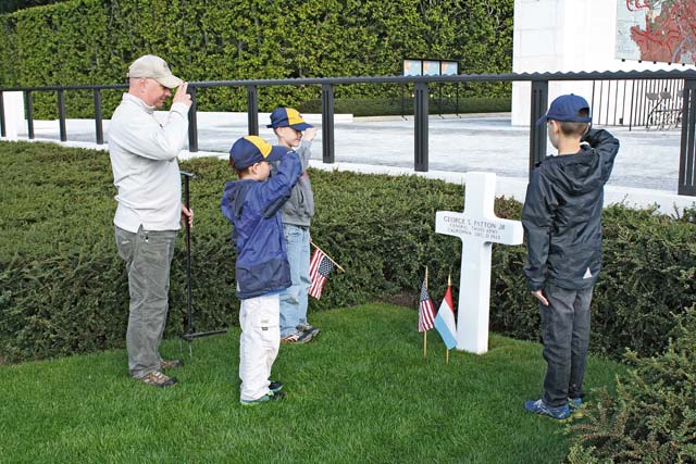 Cub Scouts from Pack 243 render a salute to the grave of Gen. George S. Patton at the Luxembourg American Cemetery and Memorial May 26. More than 100 Cub Scouts and family members from around Germany gathered to pay tribute to the men and women who paid the ultimate sacrifice.
