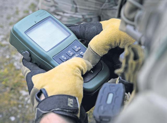 Airman 1st Class Matthew Smith, 435th Air Ground Operation Wing’s 2nd Air Support  Operations Squadron joint tactical air controller, looks at coordinates for an airstrike on a  GPS.