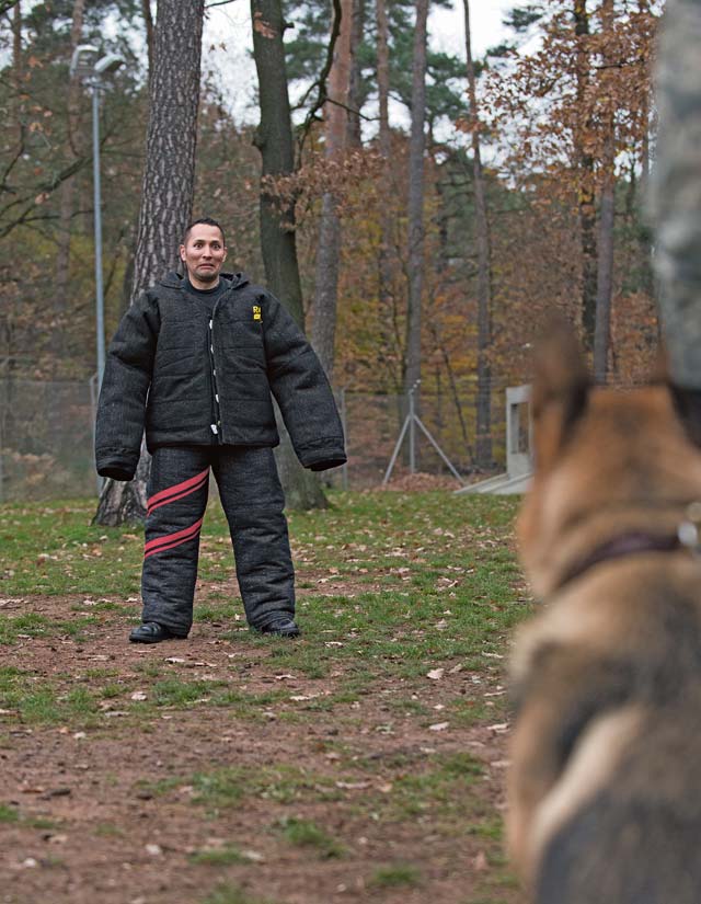 Christopher Landavazo, Cops 4 Causes president, waits to be attacked by a K-9 during a military working dog demonstration Nov. 22 on Ramstein.  Cops 4 Causes visited Ramstein as part of Operation Gratitude, where they provided 700 care packages to military members stationed here.