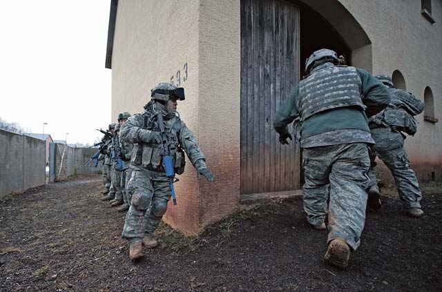 Photo by Senior Airman Damon KasbergSecurity forces members breach a building during an urban operations base security operations course. Airmen trained in many different scenarios to sharpen theirs close quarters combat skills. 