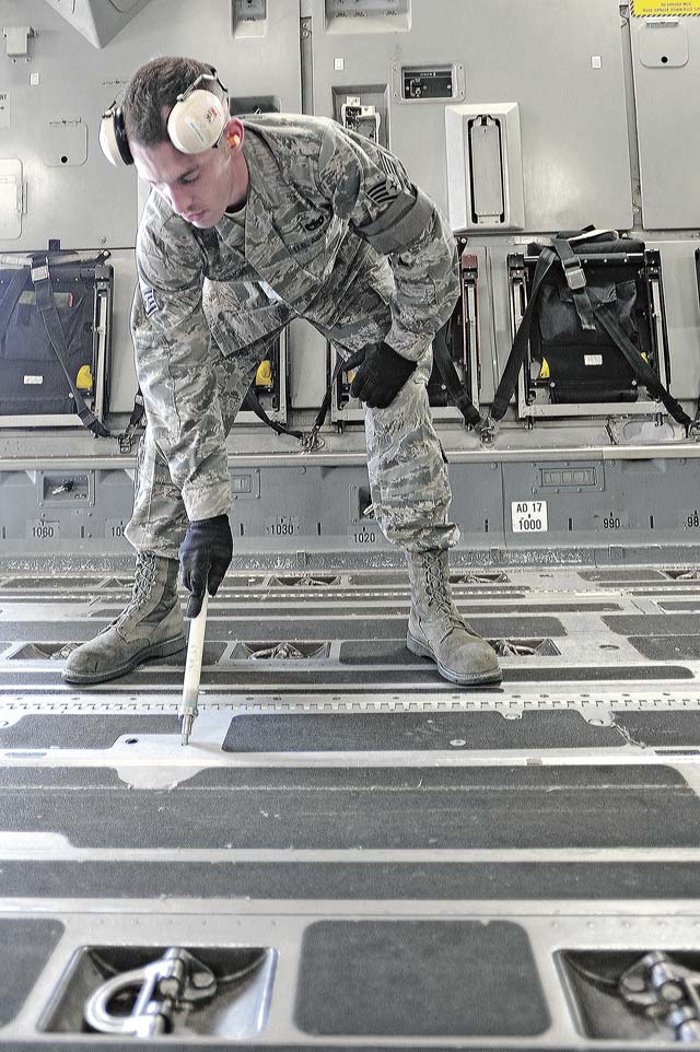 Staff Sgt. Robert Weyrough, 721st Aerial Port Squadron ramp specialist, helps prepare cargo.