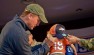 Peyton Manning, 12-time Pro Bowl quarterback for the Denver Broncos, signs a hat for a young fan.