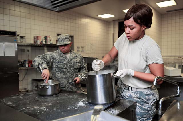 Staff Sgt. Ruben Vasquez (left), 786th Force Support Squadron food service supervisor, and Airman Savannah West, 786th FSS food services technician, prepare gravy for midnight chow.