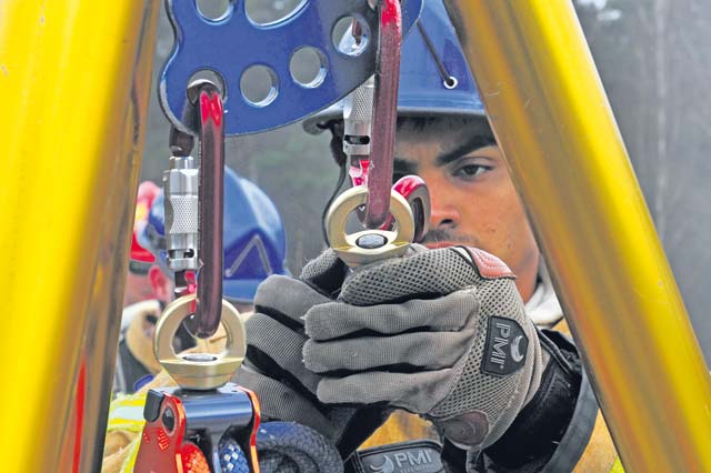 Photo by Senior Airman Aaron-Forrest Wainwright Firefighters from the 435th Civil Engineer Squadron set up a tripod March 21 on top of the training facility on Ramstein in order to pull any potential victims out of harm’s way. The 435th Construction Training Squadron conducted rescue technician certification training that tested 11 firefighters in simulated rescue operations.