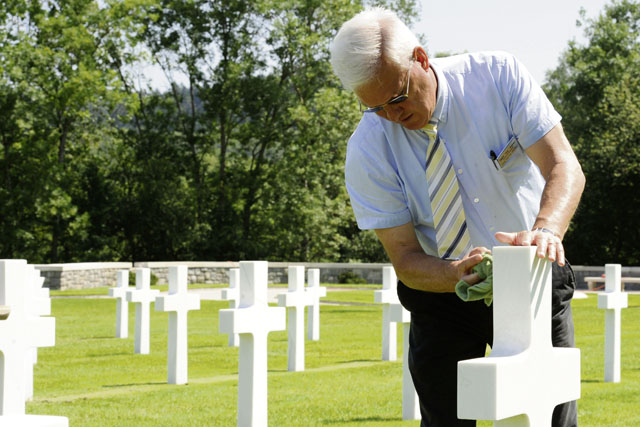 Retired Command Sgt. Maj. Dwight “Andy” Anderson, the Epinal American Cemetery superintendent, cleans a headstone July 8. Epinal American Cemetery and Memorial is the resting place of 5,255 U.S. Soldiers killed  during World War II.