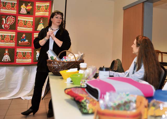 Army Reserve Lt. Col. and Department of the Army civilian Margaret R. Fierst, 21st Theater Sustainment Command’s transformation section chief, discusses an upcoming quilting trip during the Rheinland-Pfalz Quilt Guild weekly Stitch and Gab meeting Feb. 21 on Vogelweh Military Complex.
