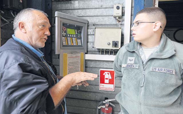 Guenter Spletter explains the wash rack operating controls to Senior Airman Matthew Jensen, both 86th Vehicle Readiness Squadron vehicle operators, Sept. 12 on Ramstein. The wash rack services approximately 1,800 government motor vehicles in the KMC.