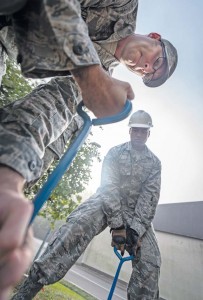 Staff Sgt. Aaron Kline (left), 86th Communications Squadron cable systems crew chief, and Senior Airman Joshua Cruz, 86th CS cable and antenna maintenance specialist, prepare to reinsert a manhole cover Oct. 2 on Ramstein.