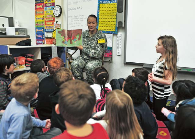 Lt. Col. Patricia K. Wright, 21st Theater Sustainment Command’s 21st Special Troops Battalion commander, reads “My Brother Charlie,” by Holly Robinson Peete, to a classroom of first-graders Feb. 7 at Kaiserslautern Elementary School on Vogelweh Military Complex.