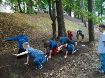 Courtesy photoMini-Mudders crawl through the dirt during physical training with the Ramstein Youth Program’s Tough Mudder Club, which is an eight-week program filled with challenging, muddy obstacles.