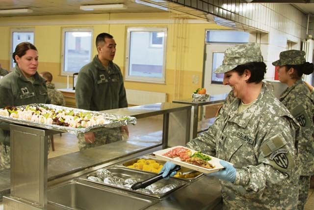 Spc. Melissa Rangle, a food service specialist assigned to the 529th Military Police Company, serves members of the 18th Military Police Brigade during their mission readiness exercise March 21.