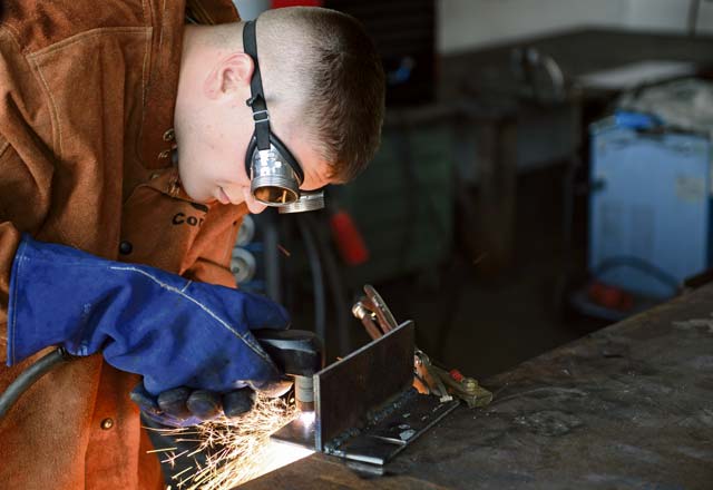 Photo by Airman 1st Class Michael Stuart  Airman First Class Brandon Slagle, 786th Civil Engineer Squadron structural journeyman, welds metal plates together on Ramstein Air Base, Germany, Aug. 6, 2014. Welding is the joining of two or more metals to repair or build structures by melting two materials together and forming a solid joint. The 786th CES builds and maintains structures and utilities on and off Ramstein. 