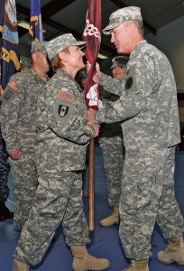 Photo by Phil A. Jones Col. Judith Lee accepts the Landstuhl Regional Medical Center colors from Col. (Dr.) Jeffrey Clark signifying Lee as the new LRMC commander during a May 29 change of  command ceremony.