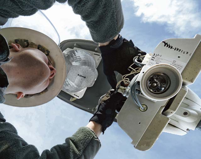 Photo by Airman Dymekre AllenAirman 1st Class Zachary Reinert, 786th Civil Engineer Squadron electrical systems technician, repairs the wires of a street lamp Feb. 6 on Ramstein. Members of the 786th CES work more than 480 man-hours per month to keep Ramstein’s street lights working properly.