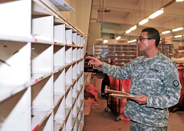 Sgt. Victor Rincon, postal NCO assigned to the 35th Infantry Division, distributes mail Jan. 29 at the Mail Distribution Node on Panzer Kaserne in Kaiserslautern. Rincon and nine other Soldiers from across the Army received postal operations training from the 21st Theater Sustainment Command and U.S. Army Garrison Rheinland-Pfalz Jan. 13 through 30.