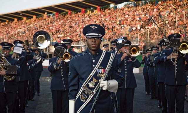 Photo by Airman 1st Class Jordan Castelan  Senior Airman Christopher Jackson, U.S. Air Forces in Europe Band drum major, prepares to lead the USAFE Band during the opening ceremonies of the 2014 NitrOlympX Fédération Internationale de l’Automobile & Fédération Internationale de Motocyclisme Drag Racing Championship at Hockenheim Ring, Germany, Aug. 9, 2014. Air Force bands support the global Air Force mission in war and peace by preserving national heritage, providing professional musical products and services for official military, recruiting and community events.