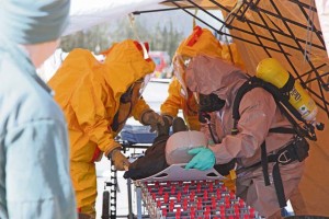 Army Sgt. 1st Class Garret Mitchell (right), logistics NCO, 773rd Civil Support Team, 7th Civil Support Command, helps Zaventem Fire Department firefighters decontaminate a simulated victim during Chemical, Biological, Radiological and Nuclear training with the Zaventem Fire Department during the fifth annual CBRN Week training exercise March 24 to 28.