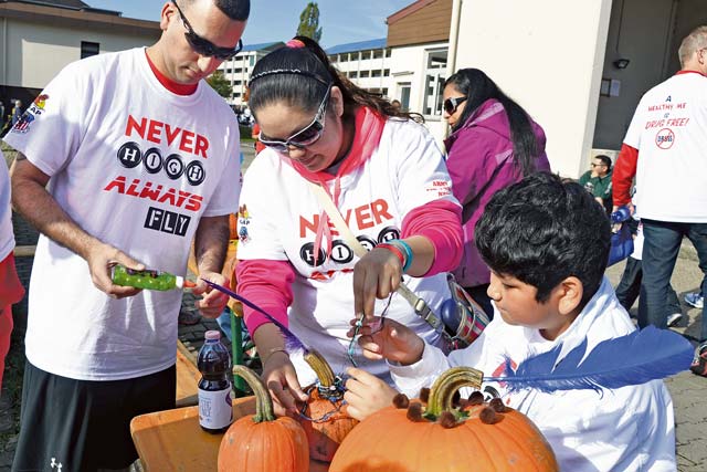 Photo by Rick ScavettaFamilies take part in fun activities, including a haunted house, mask making, make your own zombie T-shirt and pumpkin decorating.