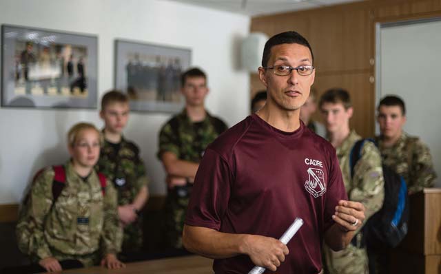 Photo by Airman 1st Class Jordan CastelanTech. Sgt. Alexander Ortiz, U.S. Air Forces in Europe Kisling Noncommissioned Officer Academy instructor, briefs a group of British Air Training Corps cadets about life as a student at the Kisling NCOA Aug. 14, 2014, on Vogelweh. The cadets from England, Wales and Northern Ireland took part in the event that immersed them in the life of a U.S. Air Force NCO attending the Kisling NCOA. 