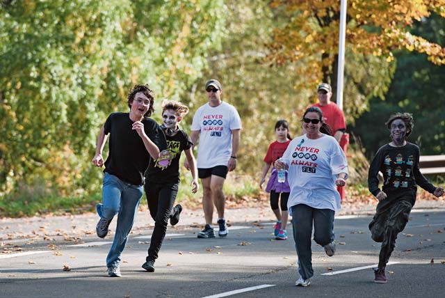Photo by Senior Airman Damon KasbergParticipants in a 5K Red Ribbon Zombie Run sprint away from zombies Oct. 19 on Sembach Kaserne. 