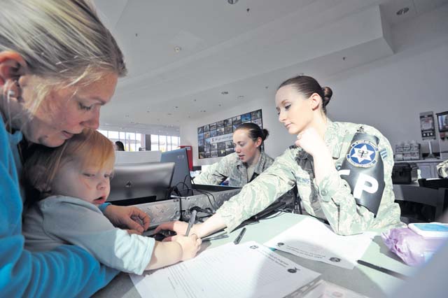 Photo by Senior Airman Aaron-Forrest WainwrightSenior Airman Paige Dowling, 569th U.S. Forces Police Squadron police officer, and Senior Airman Lindsay May, 86th Security Forces Squadron defender, input children’s information into the child identification kit during the Joint Crime Watch Prevention Day event held by the 86th SFS, 569th SFS and local Polizei Tuesday on Ramstein. The Child ID kit helps military security forces in the KMC identify and find lost children.