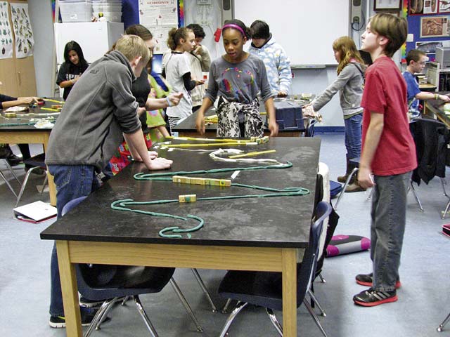 Courtesy photo‘Race to be slow’Landstuhl Elementary-Middle School students in Michael Roylance’s sixth grade science class are challenged to build a course that would slow down the transformation of potential into kinetic energy of a marble rolling down a table. The students in this “Race To Be Slow” who increased the time the most, won.