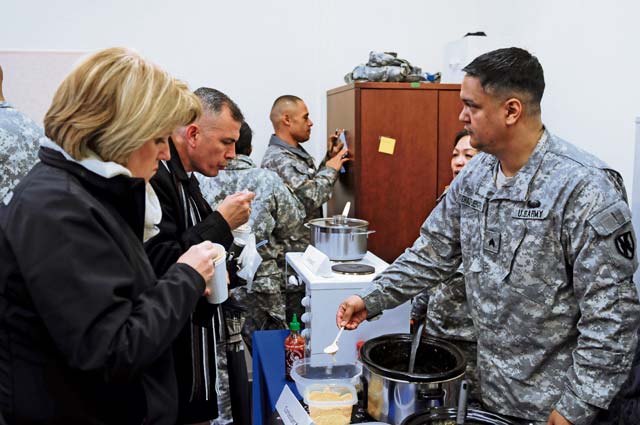 Photo by Brandon BeachMembers of the KMC sample chili prepared by Sgt. Juan DiazFuentes, 21st Theater Sustainment Command Support Operations material management NCOIC, during a chili cook-off event Feb. 7 on Panzer Kaserne. Proceeds from the event will go to support the 21st TSC Family Readiness Group. Winners of the chili cook-off were: Chris Norris, logistics management specialist, 21st TSC Support Operations Maintenance Section, for best tasting chili; Sgt. Juan DiazFuentes, material management NCOIC, 21st TSC Support Operations, for most unique chili; and Master Sgt. Kory Ysen, operations sergeant, 21st TSC Special Troops Battalion, for spiciest chili.