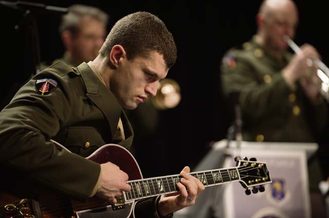 Staff Sgt. Dustin Trimble, regional guitarist for the U.S. Air Forces in Europe Band, plays a song during the event.