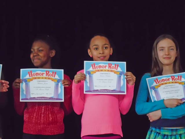 Photo by Collette CroninKaiserslautern Elementary School fourth-graders (from left) Heaven Jones, Jessica Housen and Madison Bachmann are recognized at an honor roll assembly for receiving all A’s during the quarter.