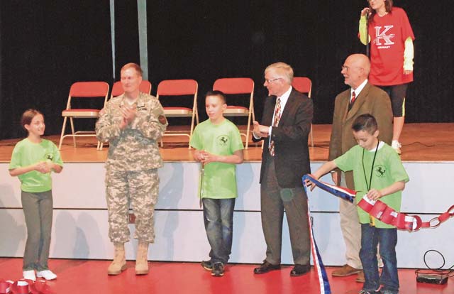 Photo by Candy LamarFrom left, Madison Bachmann; Col. Bryan DeCoster, U.S. Army Garrison Rheinland-Pfalz commander; student council president Gavin Reynolds; Johnny Edwards, 86th Mission Support Group deputy director; and Carl Albrecht, Kaiserslautern district assistant superintendent take part in a ribbon cutting ceremony Jan. 23 for Kaiserslautern Elementary School’s new multipurpose room. The new facility will act as a cafeteria, physical education room and a place to hold assemblies. KES will no longer have to share a cafeteria with middle and high school students.