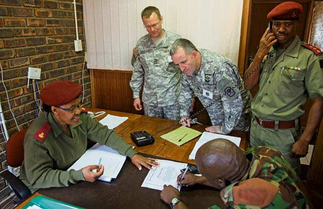 Capt. John Thruelsen (second from left), officer in charge, intelligence cell, 209th Digital Liaison Detachment, 7th Civil Support Command, and Command Sgt. Maj. Jeffrey Miller (third from left), 2500th DLD representative and senior enlisted leader, 361st Civil Affairs Brigade, 7th CSC, along with Lesotho Defence Force personnel, review MEDRETE 14-1 participant certificates Feb. 6.