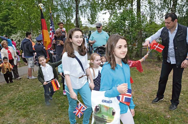 Military children march into Pulaski Park for the opening ceremony of the Month of the Military Child International Children’s Festival.