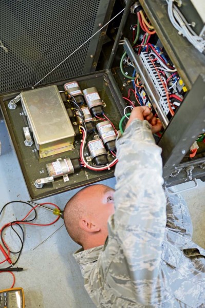 Photo by Airman 1st Class Michael Stuart  Staff Sgt. Larry Hampp, 435th Construction and Training Squadron heating ventilation air condition instructor, works on a field-deployable, environmental control unit during a seven-day heating, ventilation and air conditioning course on Ramstein Air Base, Germany, Aug. 6, 2014. The FDECU is used to control the temperature of the facilities in deployed locations and costs around $10, 800.