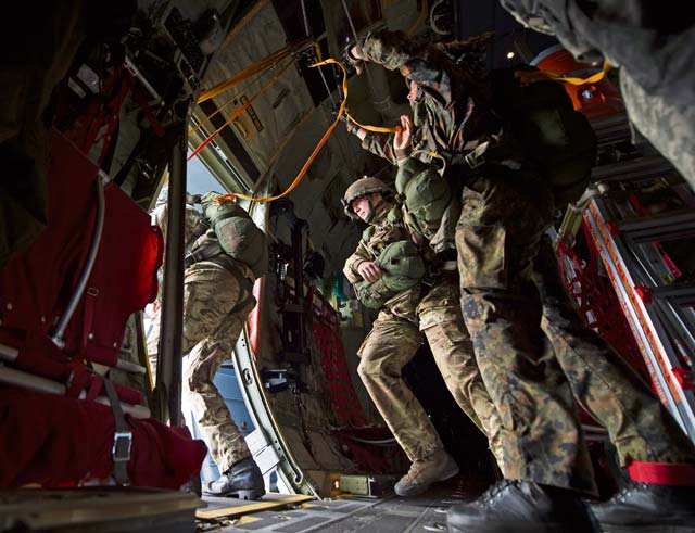 Photo by Senior Airman Damon KasbergParatroopers jump out of a U.S. Air Force C-130J Super Hercules assigned to the 37th Airlift Squadron Sept. 20, 2014, over Eindhoven, the Netherlands. Paratroopers from eight nations came to the Netherlands to re-enact the jumps made during Operation Market Garden 70 years ago. The commemoration was held to honor those who died to liberate the Netherlands. 